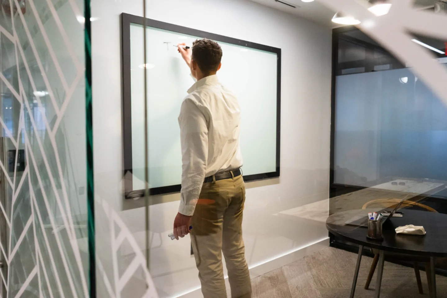 A project coordinator working through design plans on a planning board.