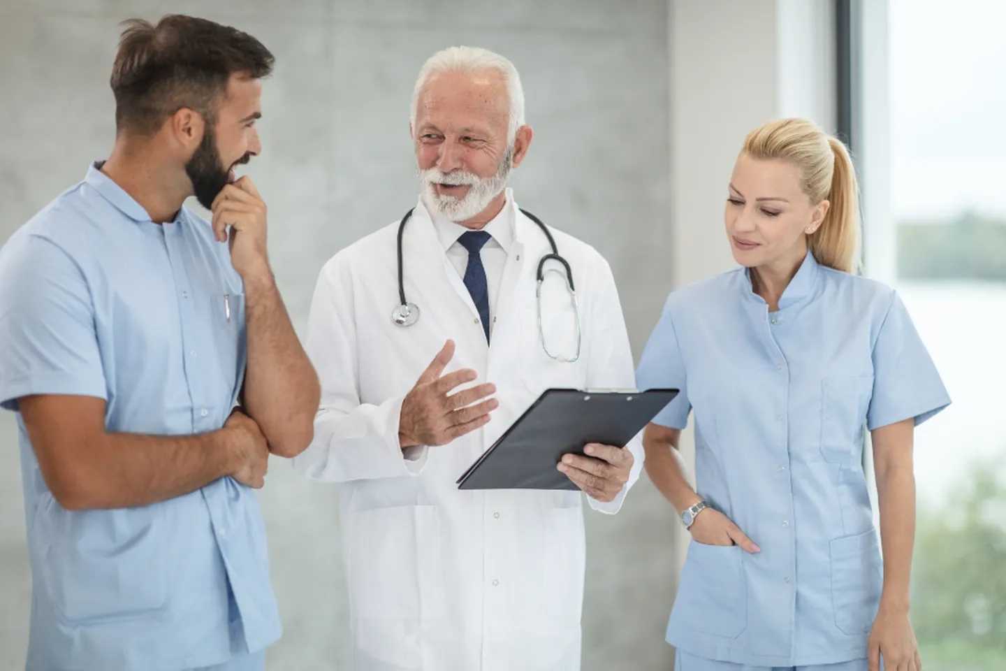 Healthcare consultants reviewing project plans together on a tablet.