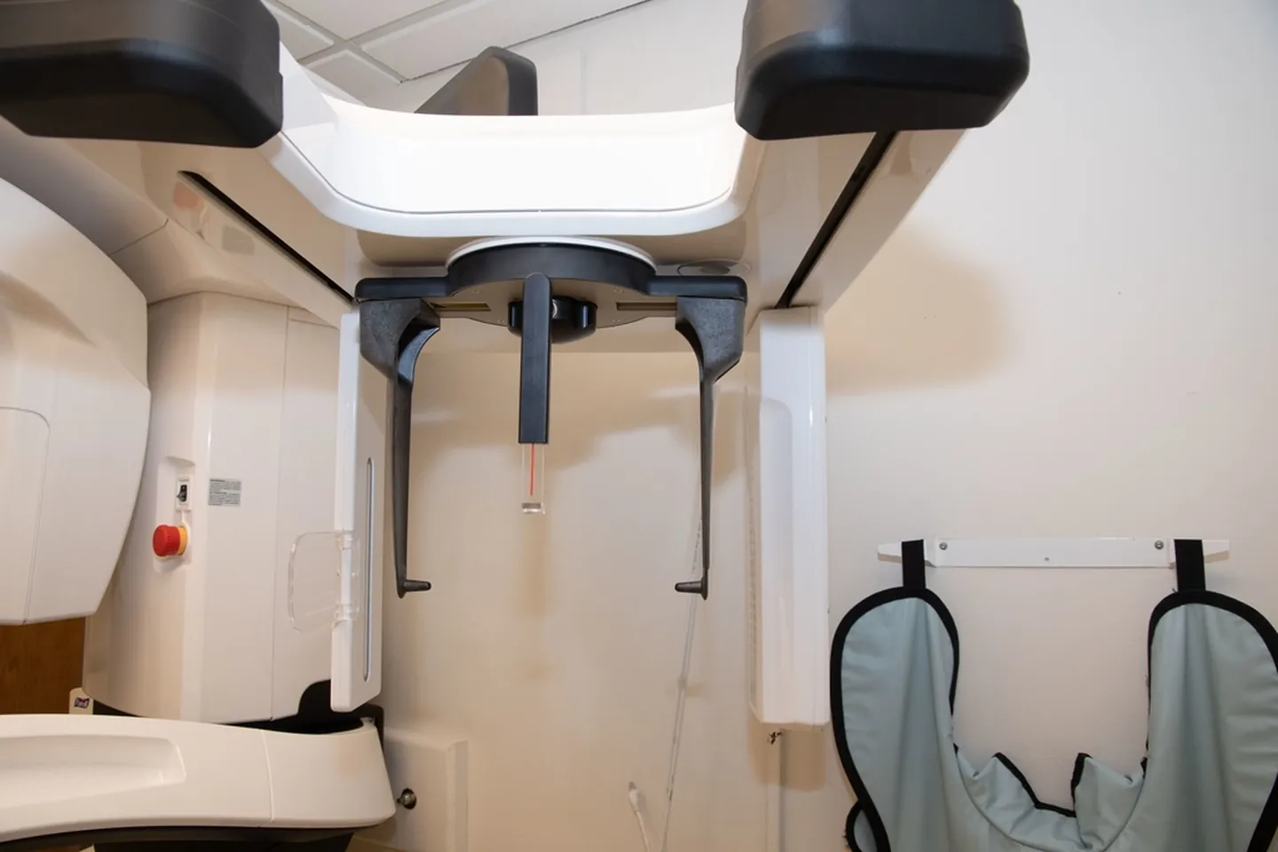 Medical imaging equipment installed in a prepared clinical room.